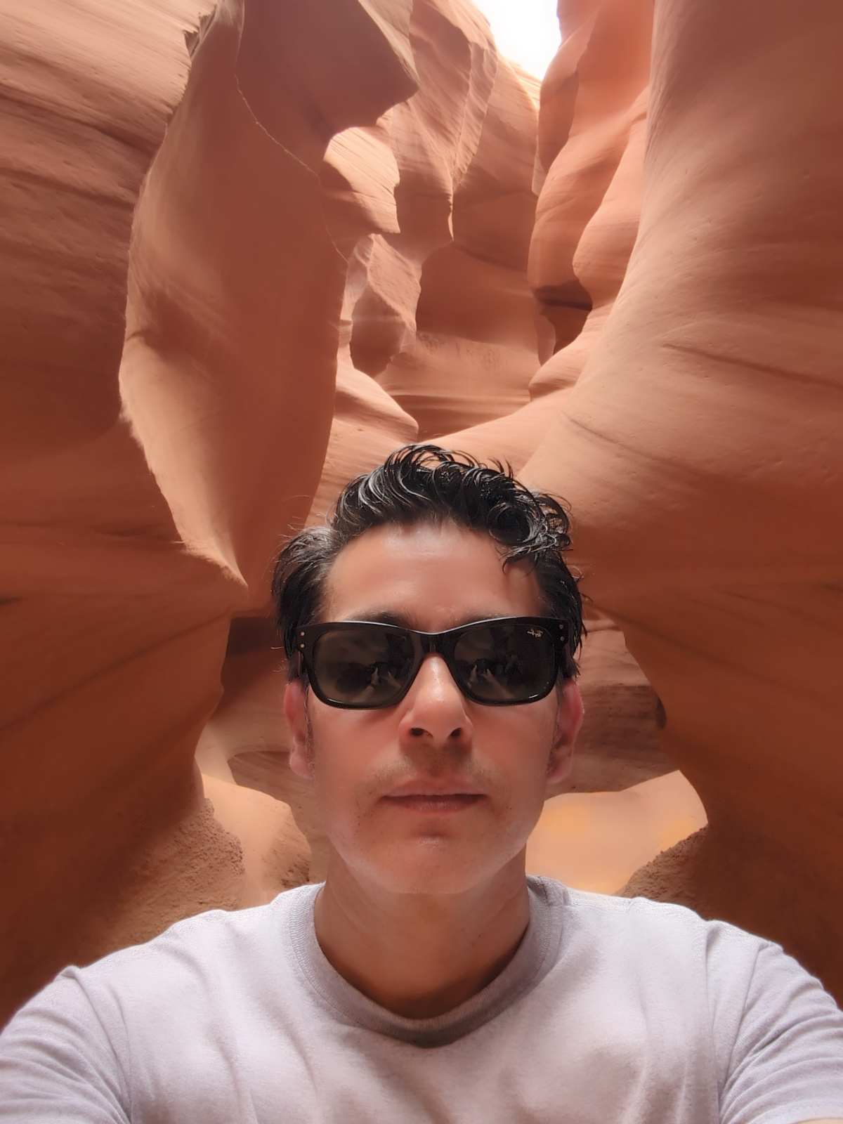 Diego inside Lower Antelope Canyon, the walls pressing in close on both sides