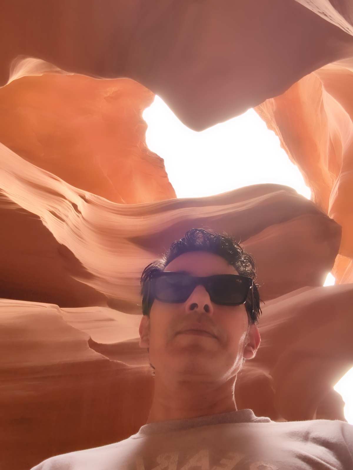 Diego inside Upper Antelope Canyon, looking up at the curved sandstone walls flowing overhead