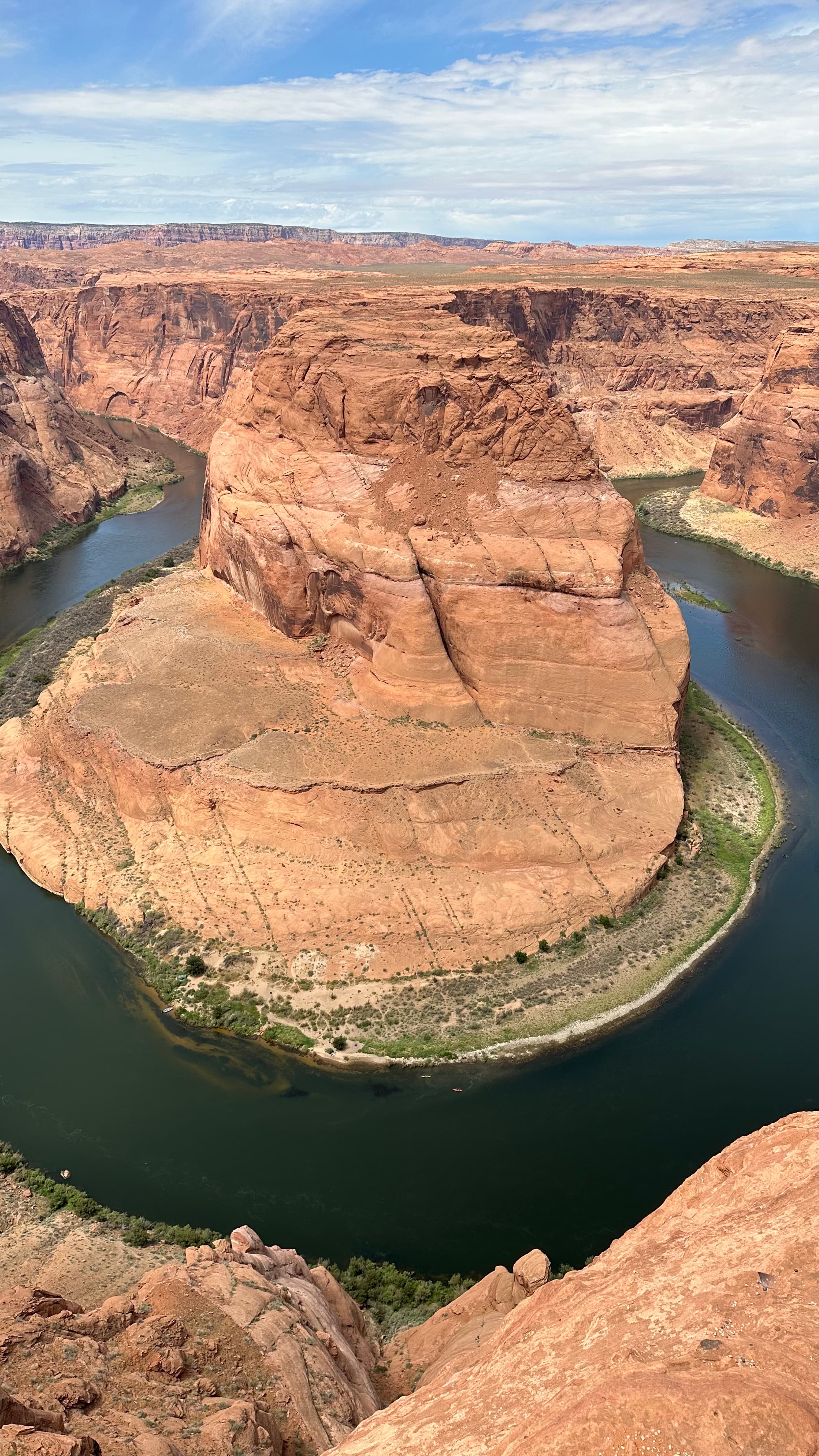 Vertical view of Horseshoe Bend showing the full 1,000-foot drop from the sandstone rim down to the Colorado River