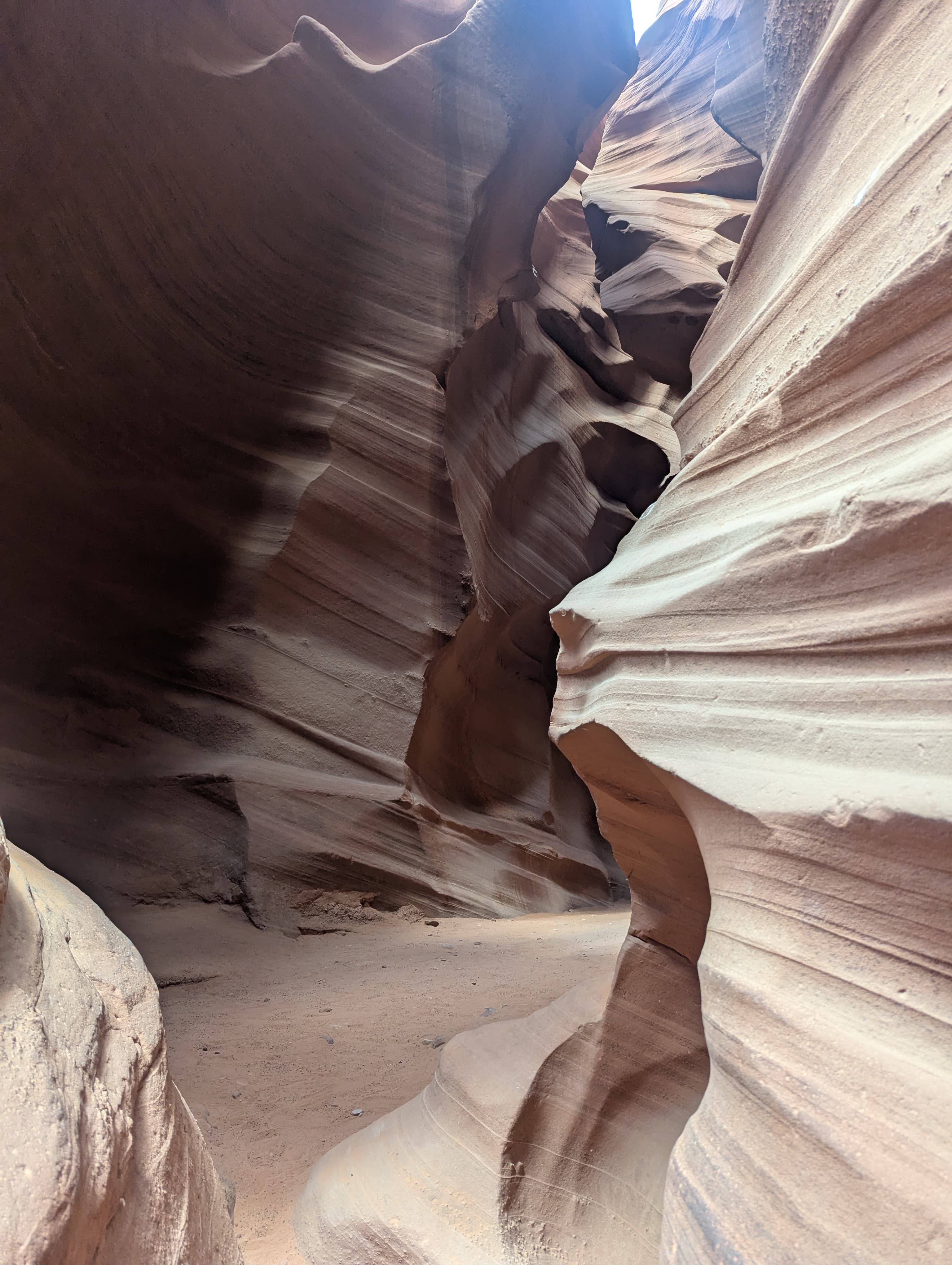 The spiraling sandstone walls inside Lower Antelope Canyon, lit in warm orange and red tones