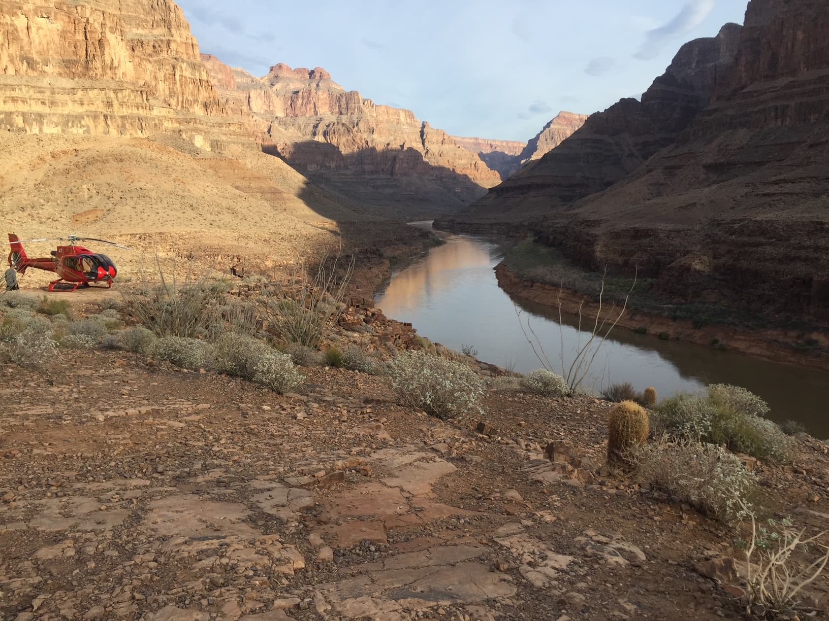 Colorado River seen from the Papillon landing platform at the Grand Canyon West Rim floor, with the canyon walls rising on both sides